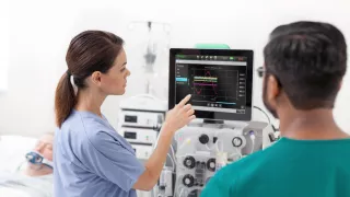 Two clinicians using the PrisMax system