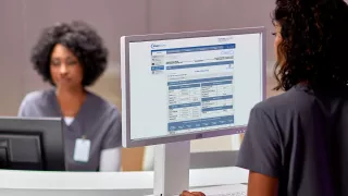 Woman on laptop viewing Sharesource remote patient management