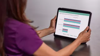 Healthcare professional viewing Sharesource Analytics on screen
