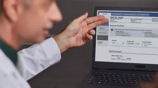 Healthcare Professional looking at Sharesource Connectivity Monitor