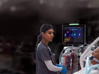 Clinician using the PrisMax system at the bedside