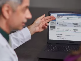 Healthcare Professional looking at Sharesource Connectivity Monitor